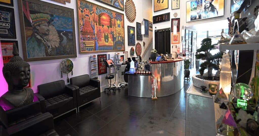 Acupuncture Zen Reception Area The art-filled reception and waiting area at Acupuncture Zen in Delray Beach, Florida, featuring a Buddha statue, original paintings, bonsai, and healing crystals