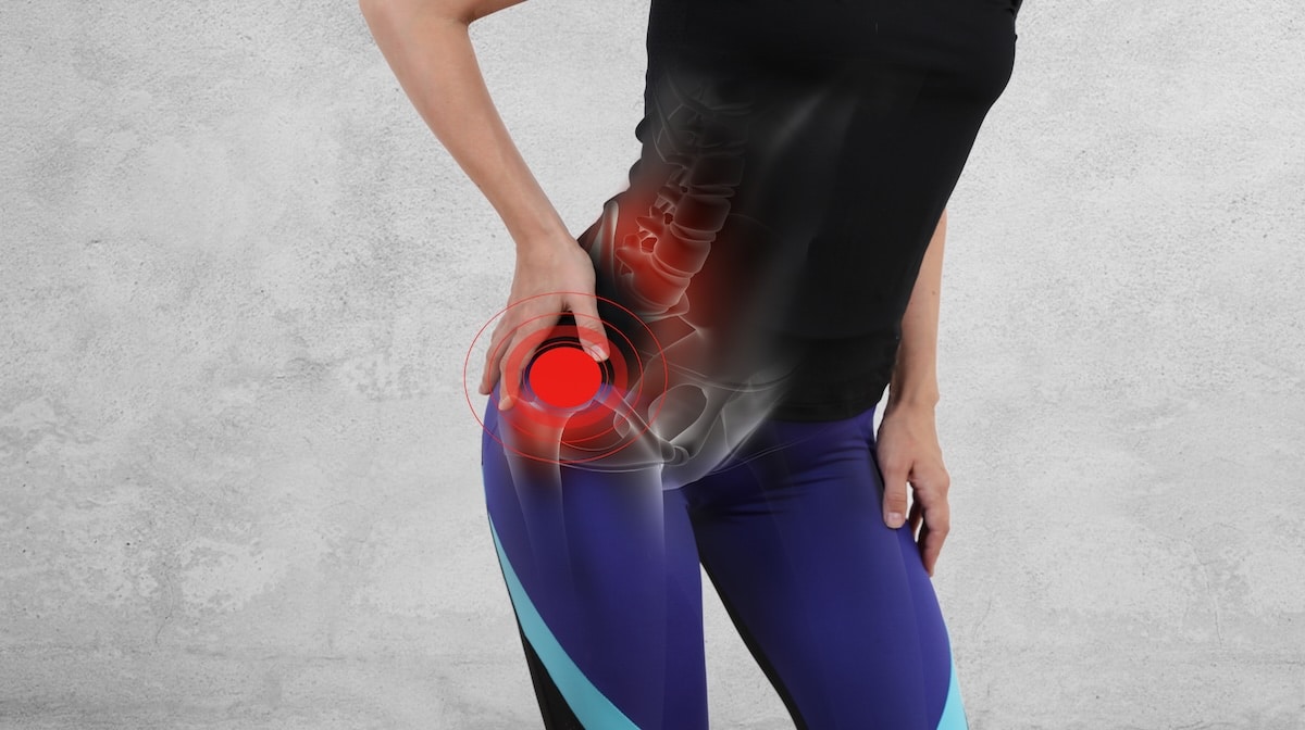 Woman holding her hip with joint pain highlighted — hip pain care at Acupuncture Zen in Delray Beach
